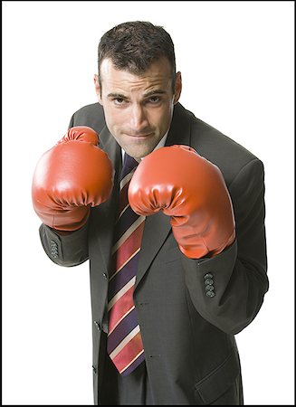 simsearch:642-01736438,k - Portrait d'un homme d'affaires avec des gants de boxe Photographie de stock - Premium Libres de Droits, Code: 640-01365321