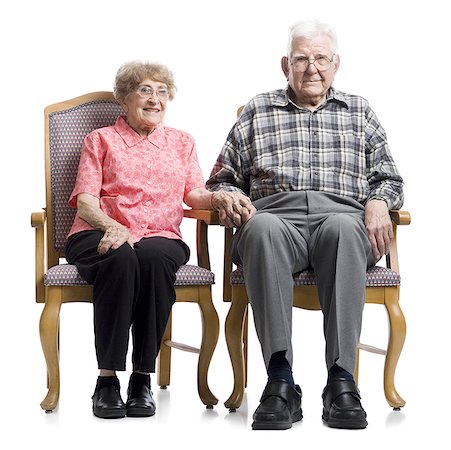 full length senior on white background - Portrait of a senior couple sitting on an armchair Stock Photo - Premium Royalty-Free, Code: 640-01365342