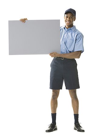 simsearch:640-01362252,k - Portrait of a young man holding a blank sign Foto de stock - Royalty Free Premium, Número: 640-01365404