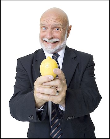 simsearch:640-01355000,k - Portrait of a businessman holding a lemon Stock Photo - Premium Royalty-Free, Code: 640-01365445