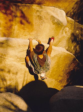 rope over cliff - High angle view of a boy rock climbing Stock Photo - Premium Royalty-Free, Code: 640-01365466