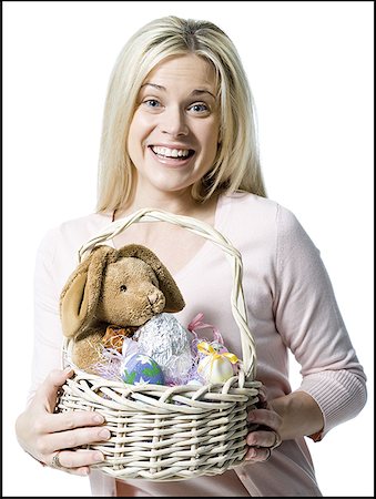 simsearch:640-01362332,k - Portrait of a young woman holding a teddy bear in a wicker basket Stock Photo - Premium Royalty-Free, Code: 640-01365487