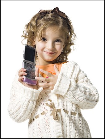 Smiling young girl in white sweater with cell phone Stock Photo - Premium Royalty-Free, Code: 640-01365510