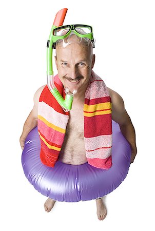 Portrait of a mature man wearing a snorkel and holding an inflatable ring Stock Photo - Premium Royalty-Free, Code: 640-01365650