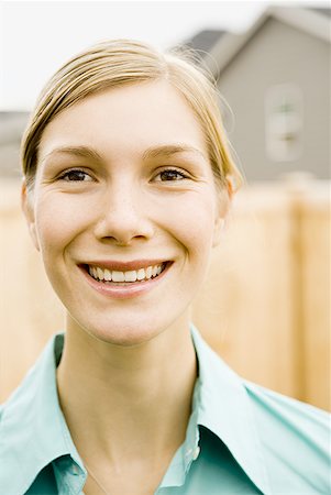 Close-up of a young woman smiling Stock Photo - Premium Royalty-Free, Code: 640-01365664