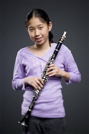 Portrait of a teenage girl holding a clarinet Stock Photo - Premium Royalty-Free, Code: 640-01365707