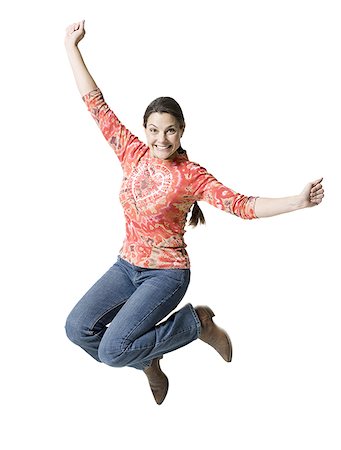 simsearch:640-03257317,k - Portrait of a woman jumping in mid air with her arms outstretched Fotografie stock - Premium Royalty-Free, Codice: 640-01365748