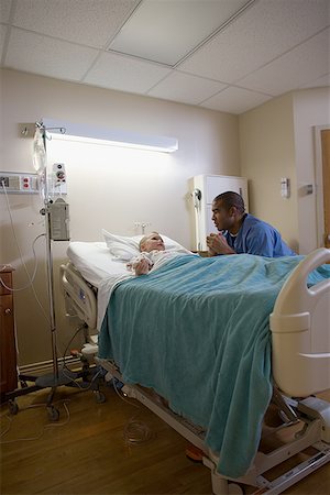 doctor patient bed side view - Male doctor consoling a boy Stock Photo - Premium Royalty-Free, Code: 640-01365906