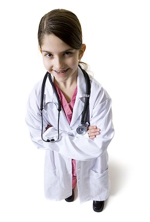 Young girl dressed as doctor with white coat and stethoscope Stock Photo - Premium Royalty-Free, Code: 640-01365979