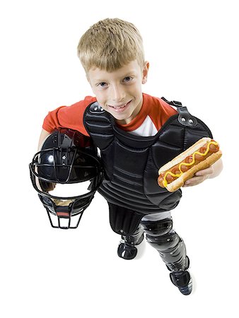 High angle view of a baseball catcher holding a baseball helmet Stock Photo - Premium Royalty-Free, Code: 640-01366000