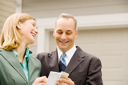 simsearch:640-01362708,k - Close-up of a businessman and a businesswoman laughing Stock Photo - Premium Royalty-Free, Code: 640-01366029