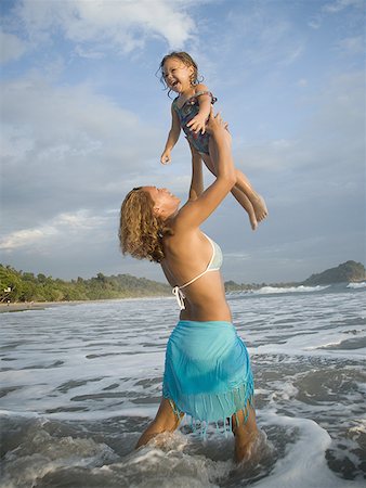 Profile of a mother woman holding up her daughter Stock Photo - Premium Royalty-Free, Code: 640-01366070