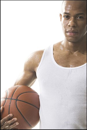 secretion - Portrait of a young man holding a basketball Foto de stock - Sin royalties Premium, Código: 640-01366087