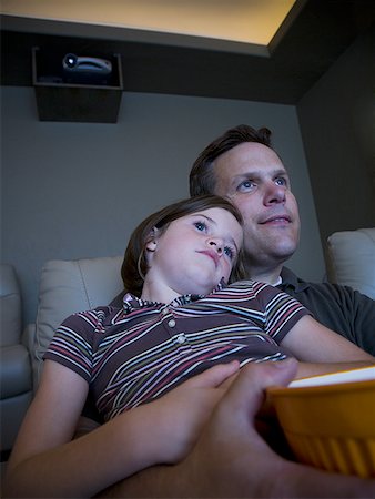 picture of happy family watching movies - Father and daughters watching movie in home theater Stock Photo - Premium Royalty-Free, Code: 640-01366154