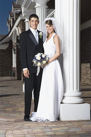 simsearch:673-02386650,k - Portrait of a newlywed couple standing together and smiling near a column Foto de stock - Sin royalties Premium, Código: 640-01366199