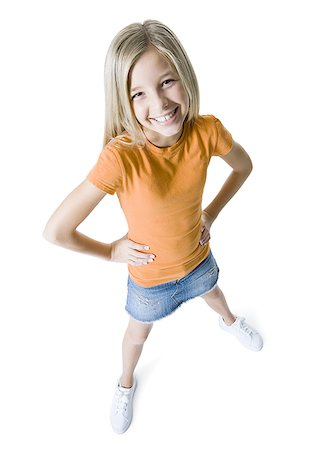 denim skirt - Portrait of a girl standing with her hands on her hips and smiling Foto de stock - Sin royalties Premium, Código: 640-01366201