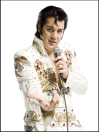 simsearch:640-01359391,k - Portrait of an Elvis impersonator singing into a microphone Foto de stock - Royalty Free Premium, Número: 640-01366250