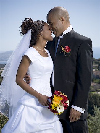 Close-up of a bride and groom standing together Stock Photo - Premium Royalty-Free, Code: 640-01366276