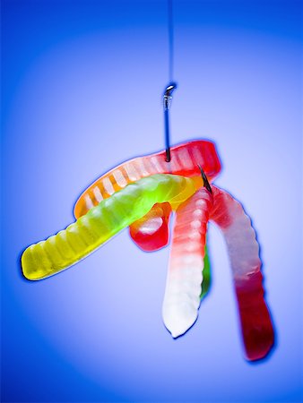 fishing hook nobody - Close-up of gummy worms hanging by a fishing hook Stock Photo - Premium Royalty-Free, Code: 640-01366271