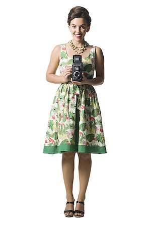 simsearch:640-01355807,k - Woman in floral dress holding antique camera Foto de stock - Sin royalties Premium, Código: 640-01366325