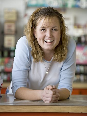 Portrait of a young woman behind a counter Stock Photo - Premium Royalty-Free, Code: 640-01366385