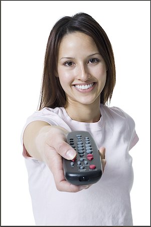 remote control, white background - Portrait of a young woman holding a remote control Stock Photo - Premium Royalty-Free, Code: 640-01366388