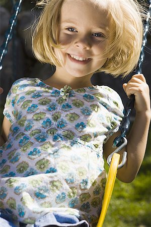 Portrait of a girl sitting on a swing Stock Photo - Premium Royalty-Free, Code: 640-01366423