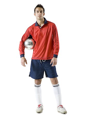 Portrait of a young man holding a soccer ball Stock Photo - Premium Royalty-Free, Code: 640-01366439