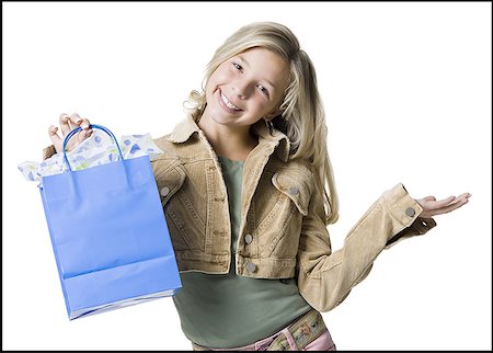 simsearch:640-01360910,k - Portrait of a girl showing a shopping bag and smiling Stock Photo - Premium Royalty-Free, Code: 640-01366462