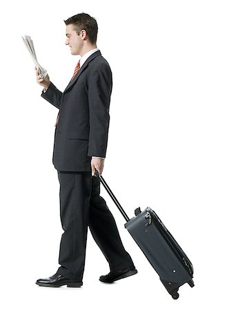 full height - Profile of a businessman walking with luggage Stock Photo - Premium Royalty-Free, Code: 640-01366612