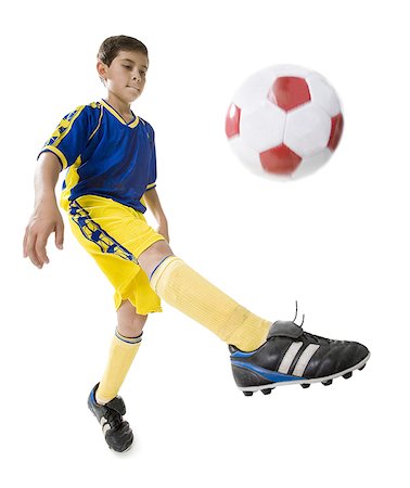 Low angle view of a boy playing soccer Stock Photo - Premium Royalty-Free, Code: 640-01360024
