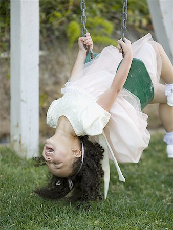 Close-up of a girl on a swing Stock Photo - Premium Royalty-Free, Code: 640-01360028