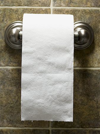 Toilet paper roll on bathroom wall Stock Photo - Premium Royalty-Free, Code: 640-01360087
