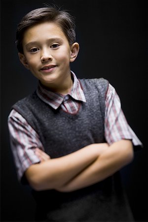 Portrait of a boy smiling with his arms crossed Stock Photo - Premium Royalty-Free, Code: 640-01360109