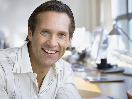 Portrait of a businessman smiling Stock Photo - Premium Royalty-Free, Code: 640-01360245