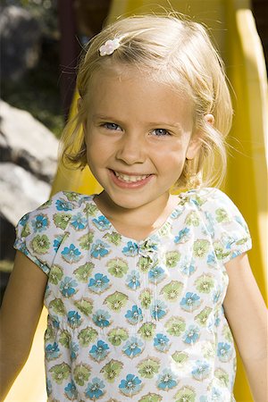 Portrait of a girl sitting on a slide Stock Photo - Premium Royalty-Free, Code: 640-01360264