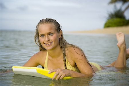 female teen soles - Portrait of a teenage girl floating on a boogie board in the sea Stock Photo - Premium Royalty-Free, Code: 640-01360277