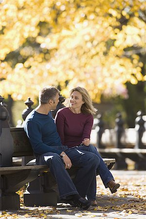 Couple sitting on a park bench Stock Photo - Premium Royalty-Free, Code: 640-01360307