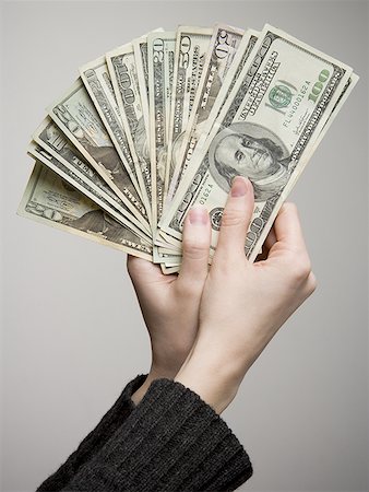 fanned out - Close-up of a person's hand holding American paper currency Stock Photo - Premium Royalty-Free, Code: 640-01360345