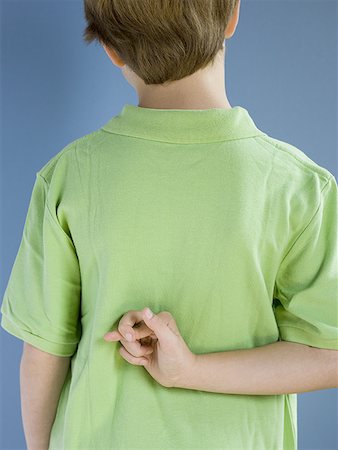 preteens fingering - Rear view of boy with fingers crossed behind back Stock Photo - Premium Royalty-Free, Code: 640-01360390