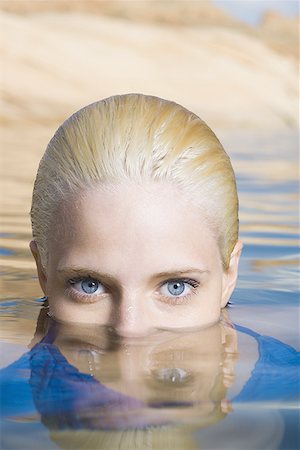 Portrait of a young woman in a lake Stock Photo - Premium Royalty-Free, Code: 640-01360468