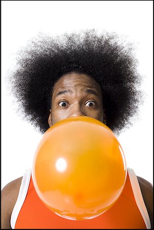 portrait chewing gum - Basketball player with an afro blowing a bubble Stock Photo - Premium Royalty-Free, Code: 640-01360492