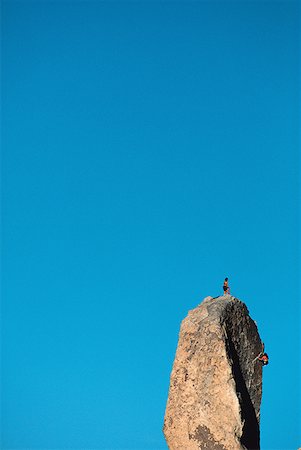 simsearch:640-01361581,k - Low angle view of a two people on the peak of a rock formation Fotografie stock - Premium Royalty-Free, Codice: 640-01360628