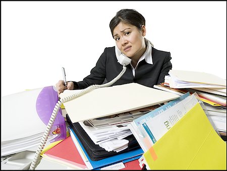 Portrait d'une femme d'affaires frustré multitâche dans un bureau Photographie de stock - Premium Libres de Droits, Code: 640-01360631