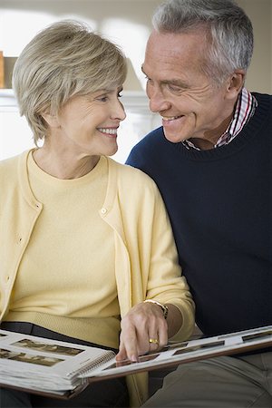 Close-up of a mature couple looking at a photo album Stock Photo - Premium Royalty-Free, Code: 640-01360719