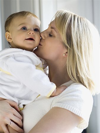 simsearch:640-02771500,k - Woman holding and kissing baby Foto de stock - Sin royalties Premium, Código: 640-01360726