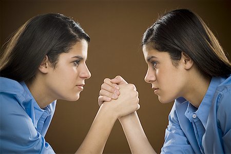 simsearch:625-00838657,k - Profile of two teenage girls arm wrestling Stock Photo - Premium Royalty-Free, Code: 640-01360754