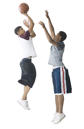 Profile of a teenage boy and a young man playing basketball Stock Photo - Premium Royalty-Free, Code: 640-01360765