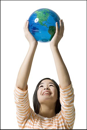 Close-up of a teenage girl holding a globe Stock Photo - Premium Royalty-Free, Code: 640-01360809