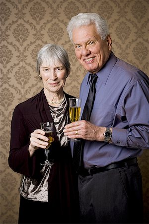 Portrait of an elderly couple holding glasses of wine Stock Photo - Premium Royalty-Free, Code: 640-01360858